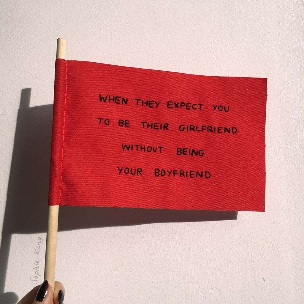 Series of embroidered textile "red flags"